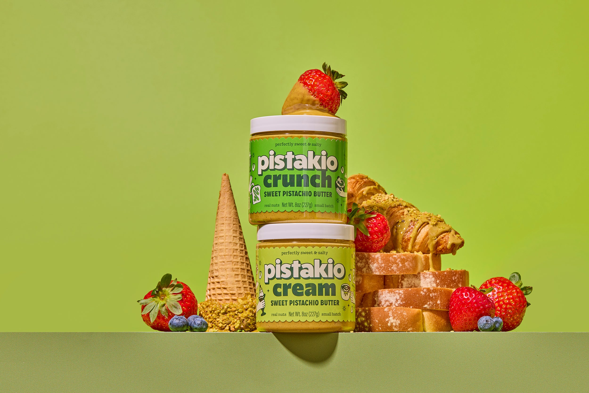 Creamy and Crunchy Pistakio jars with strawberries, toast and a pistachio croissant